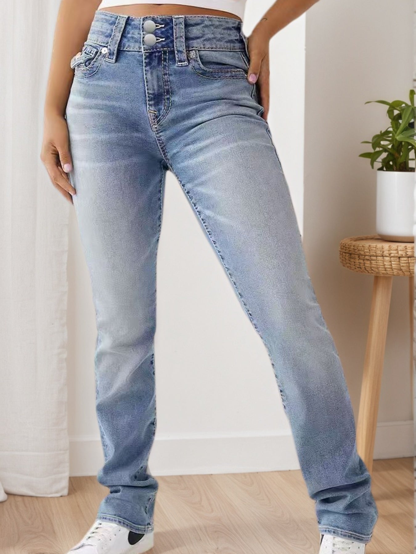 Light blue high-waisted wide-leg jeans with stitched yoke, belt loops, and button closure