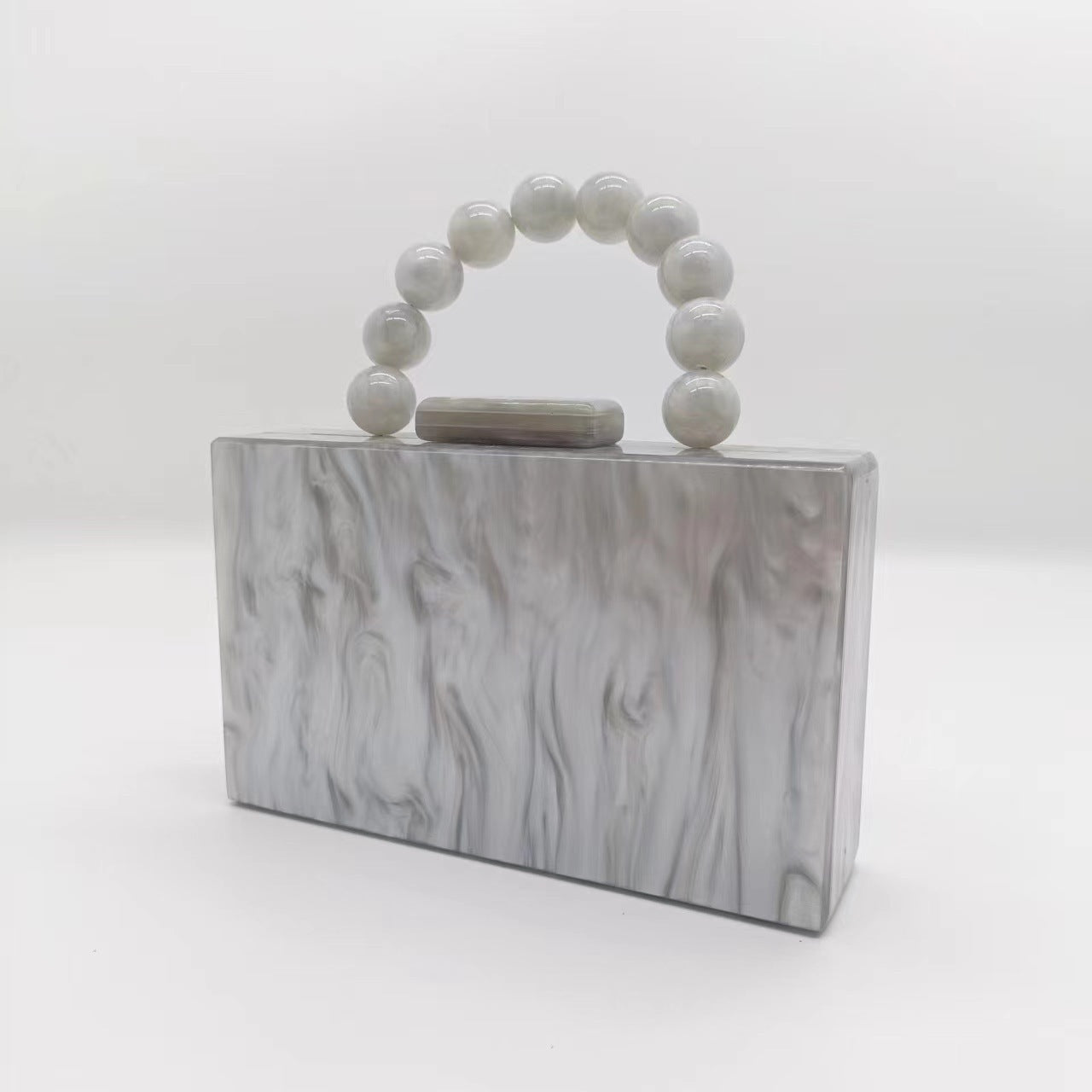 Silver gray acrylic evening bag with round beaded handle and top clasp