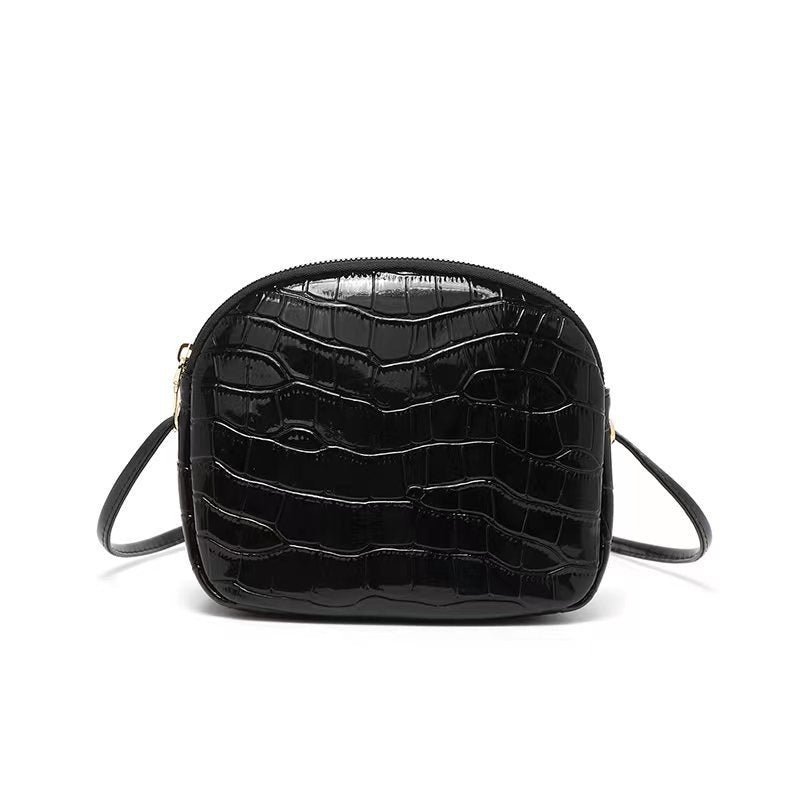 Black crocodile-texture mini shoulder bag with zipper and adjustable crossbody straps.