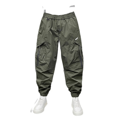 Men's tapered cropped pants, army green, front view with drawstring and cargo pockets