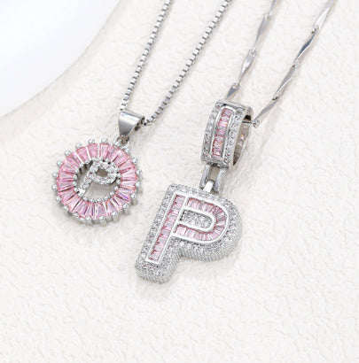 Silver pendant necklace set with pink crystal flower charm and letter pendant, three-piece detail