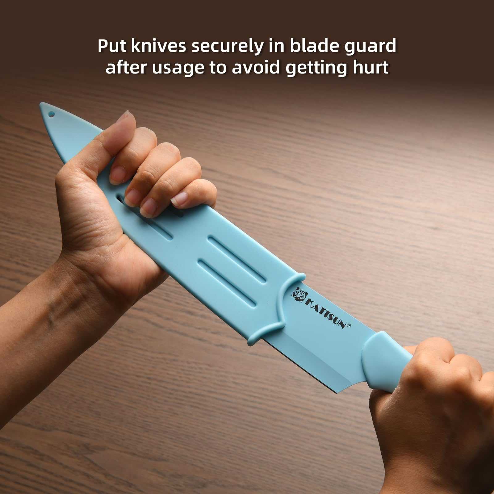 Light blue kitchen knife with blade guard, held in hand
