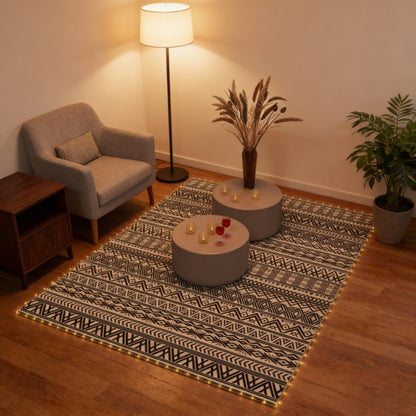 Outdoor reversible rug with black-and-white geometric pattern in an indoor room