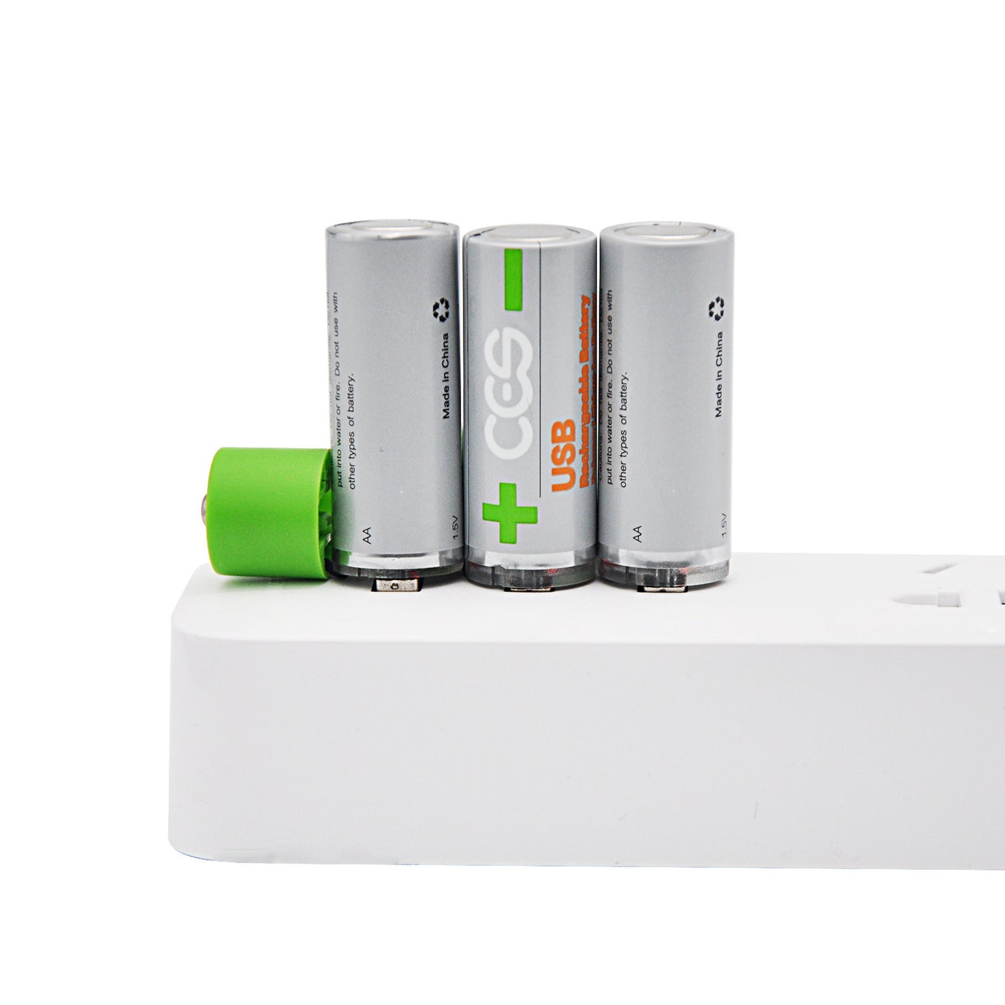 Three cylindrical batteries with a green battery on a white surface