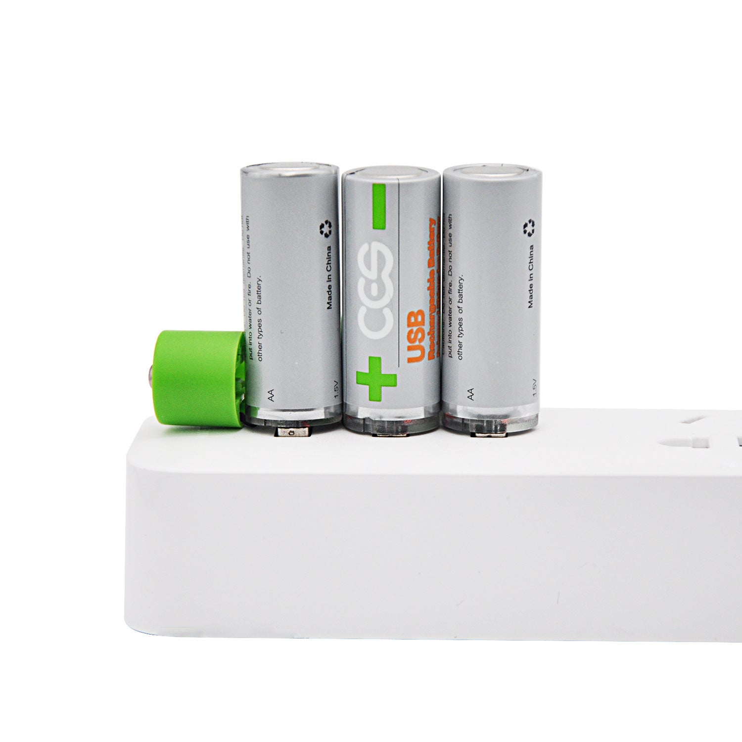 Three cylindrical batteries with a green battery on a white surface