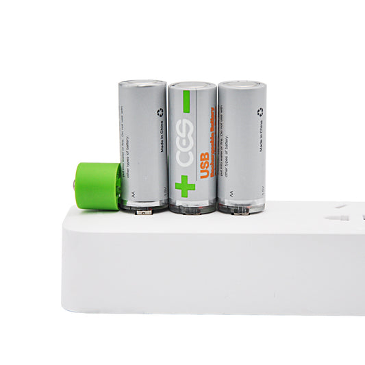 Three cylindrical batteries with a green battery on a white surface
