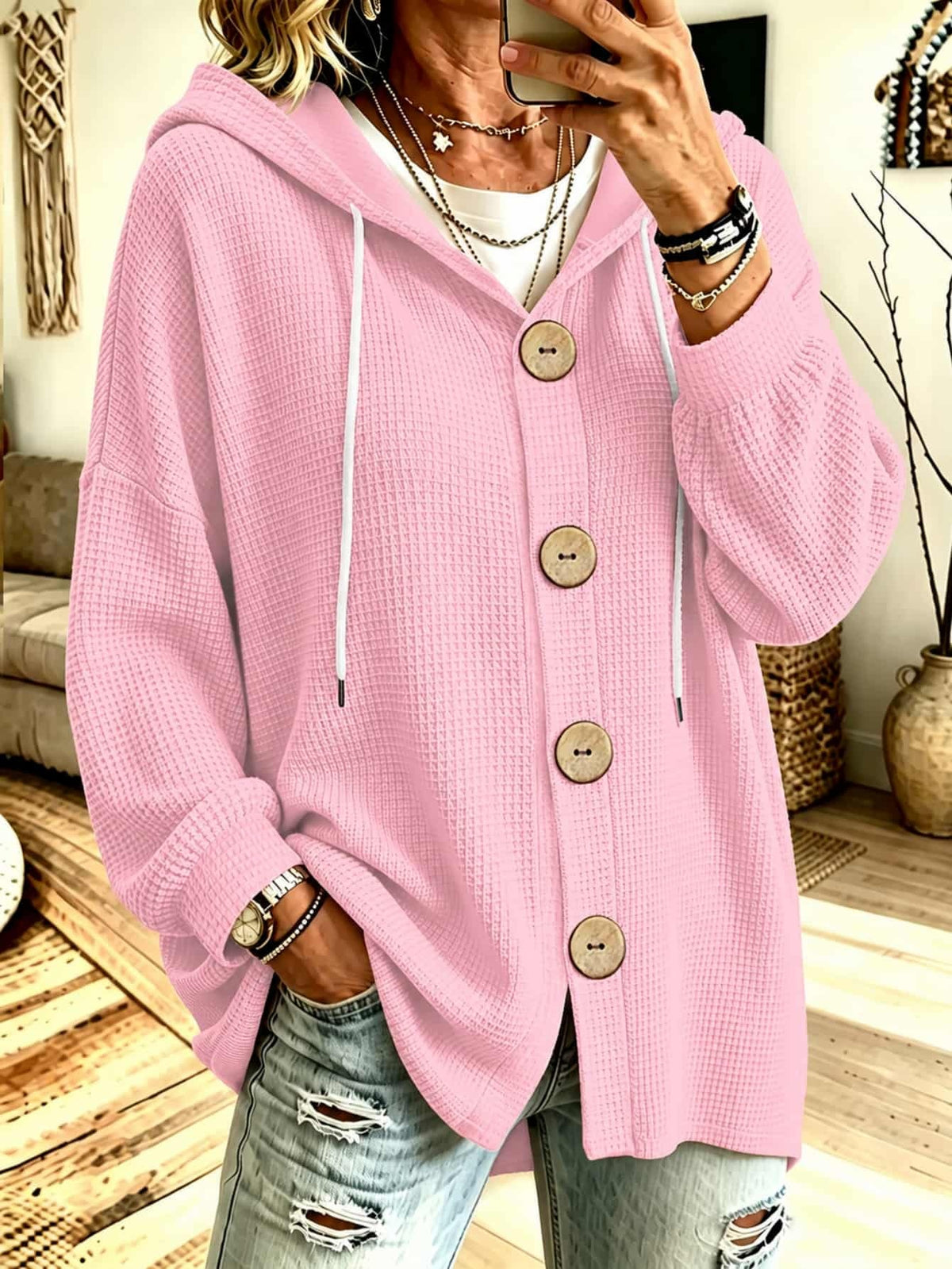 Hooded knit blouse in rose pink with long sleeves, button placket, and drawstring ties
