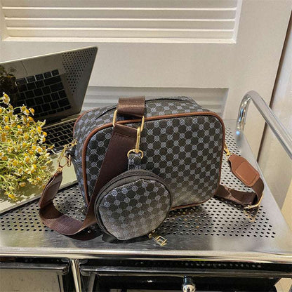 Dark patterned shell crossbody bag with long strap and round front pouch