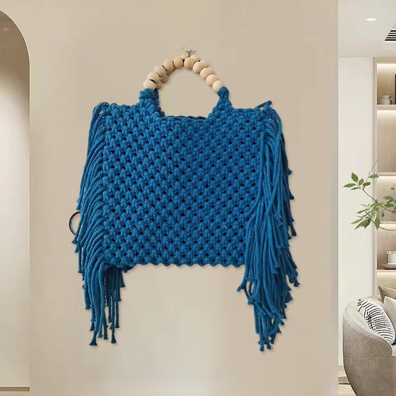 Blue woven mini crossbody bag with beaded top handle and fringe tassels