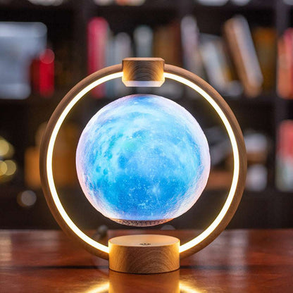 Floating moon lamp with blue glowing moon, warm LED ring, wood-toned base