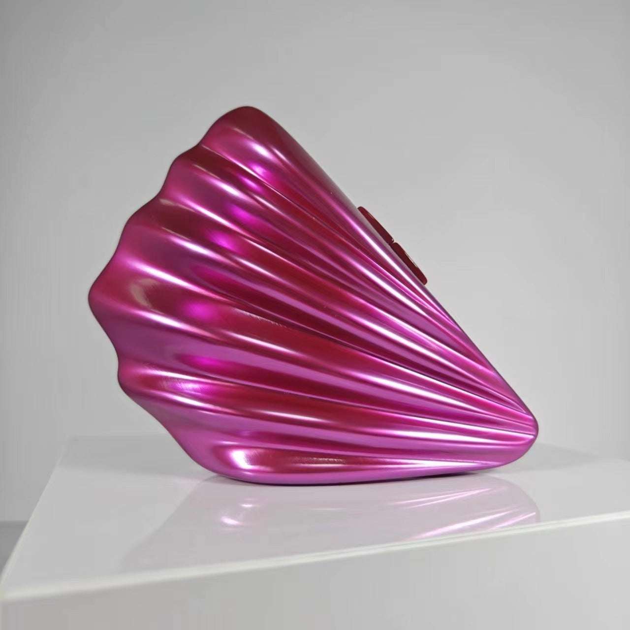 Metallic magenta shell crossbody bag with glossy ridged design