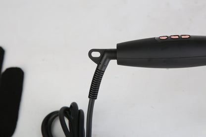 Black hot air styling brush handle with hanging power cord and control area