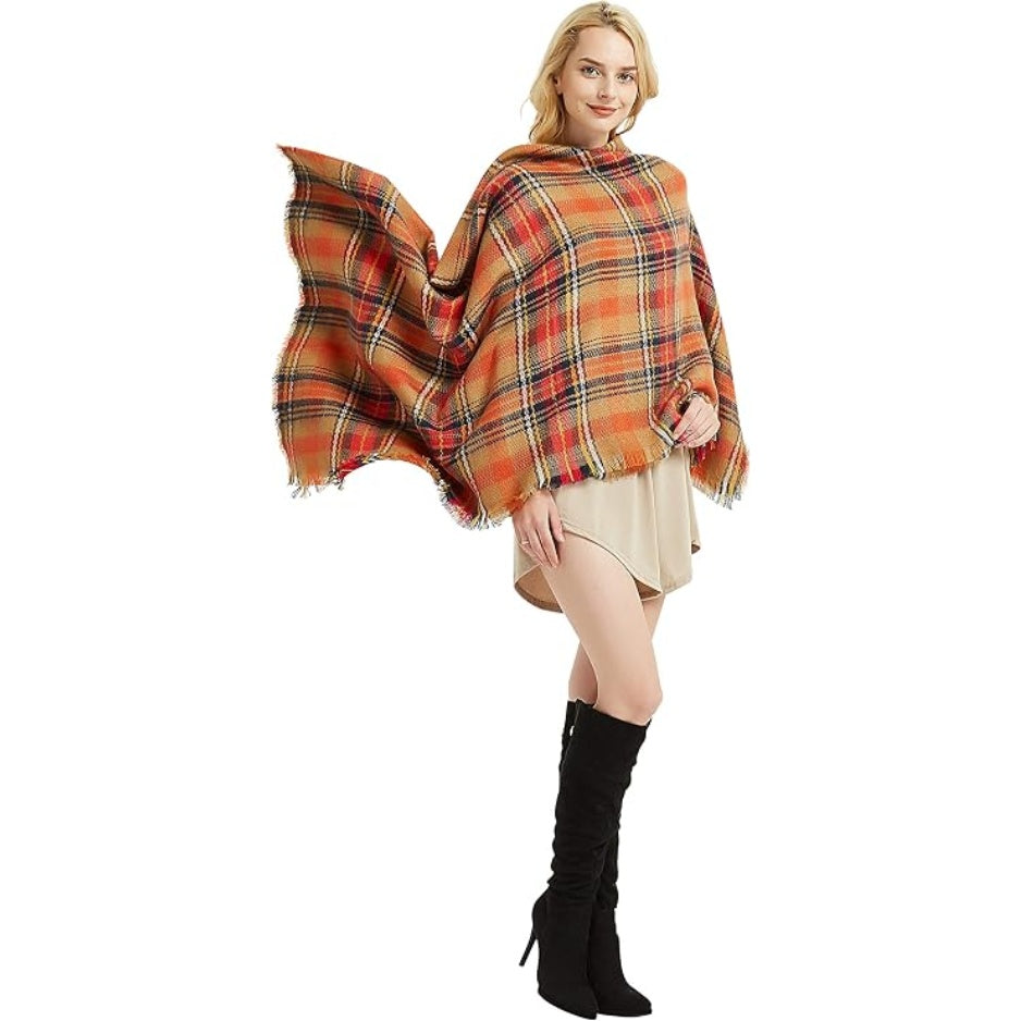 Plaid blanket scarf worn as poncho, orange and navy tartan with fringed hem