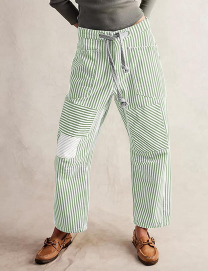 Light green-and-white striped wide-leg trousers with drawstring waist and patch pockets