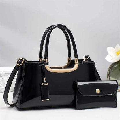 Black hobo shoulder bag with gold-tone handles and matching flap wallet pouch