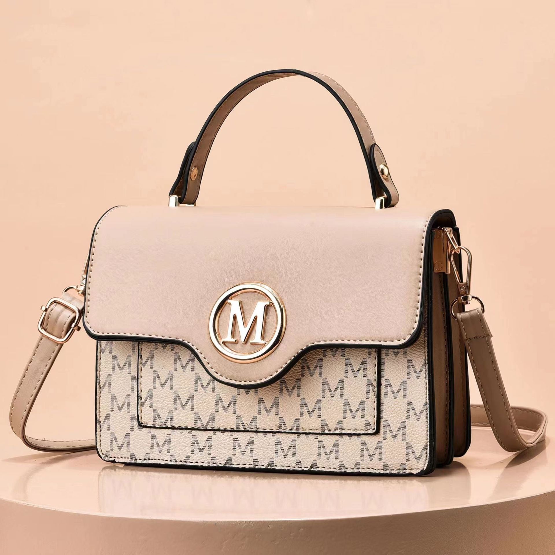 Light beige printed shoulder bag with flap, top handles, M logo, and crossbody strap