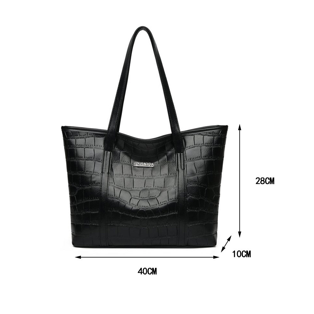 Large black croc-embossed tote bag with top handles and front logo patch; measurements