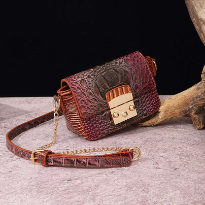 Burgundy one-shoulder crossbody bag with crocodile texture, gold-tone clasp, chain strap.