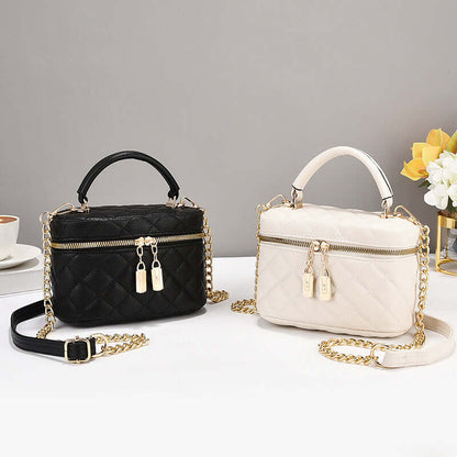 Black quilted fashion tote with short handle, gold chain strap, double zip pulls
