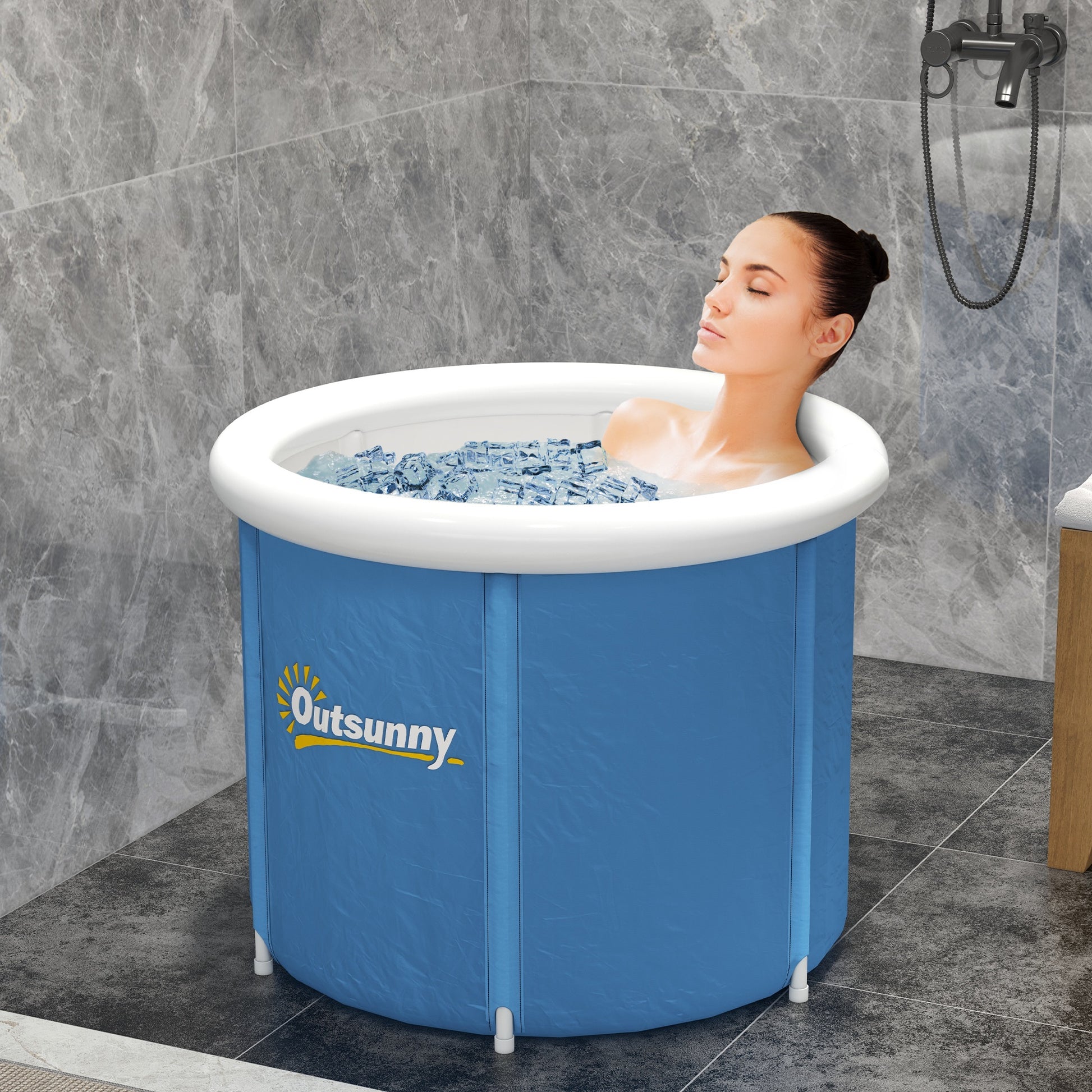 Blue portable cold plunge tub with white rim, with a person soaking in water