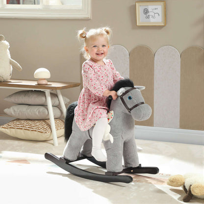Toddler riding a gray plush rocking horse toy with black mane, rabbit doll attached