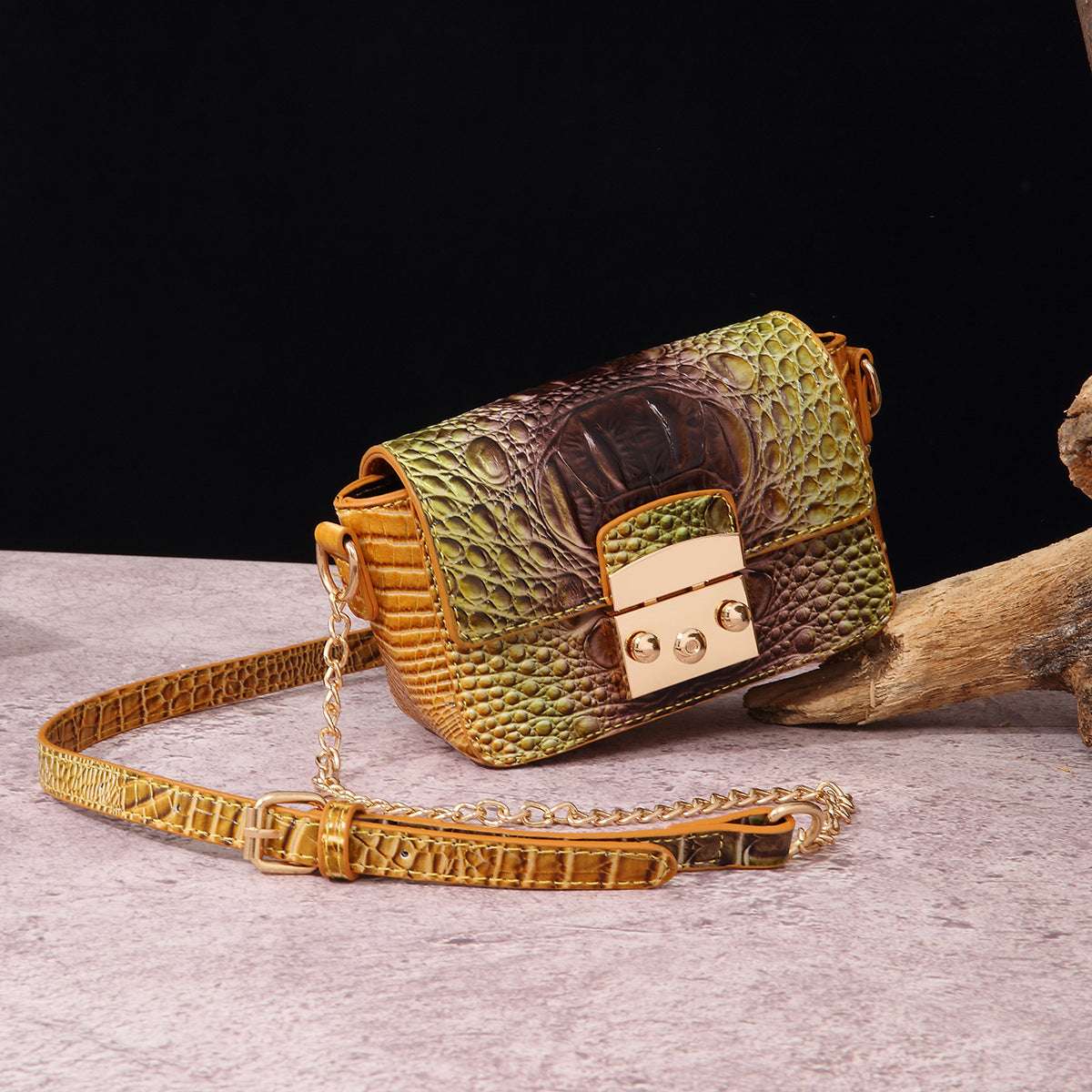 Olive-and-brown one-shoulder crossbody bag with crocodile texture, gold-tone clasp and chain strap.