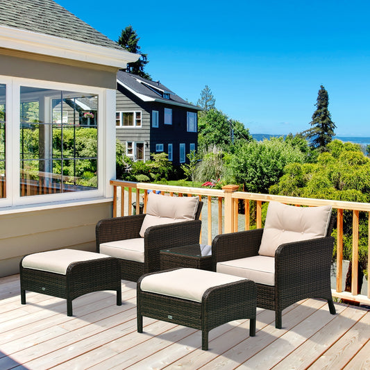 5-piece brown rattan wicker patio set with beige cushioned lounge chairs, two ottomans, and a tempered glass coffee table