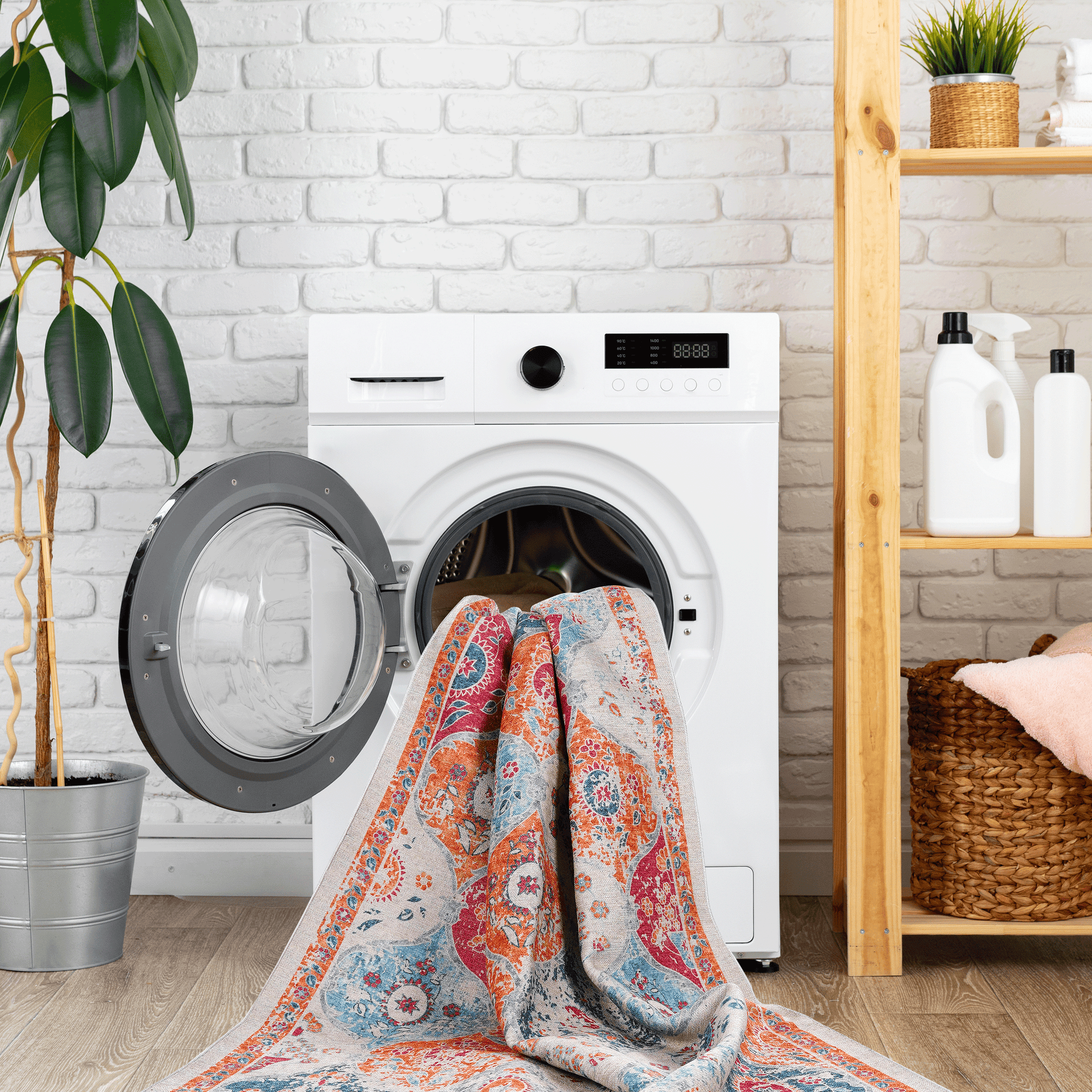 Washable area rug folded on a front-load washer, cream with blue and orange pattern
