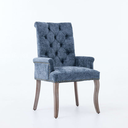 Blue accent dining chair with tufted back, wide upholstered arms, and four tapered wooden legs