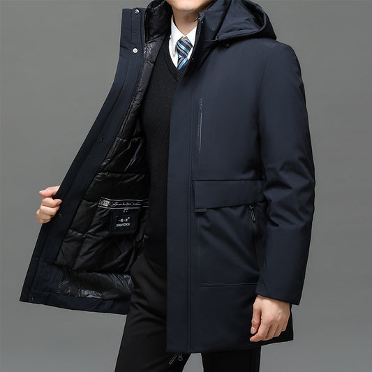 Person wearing a dark blue coat with a gray background