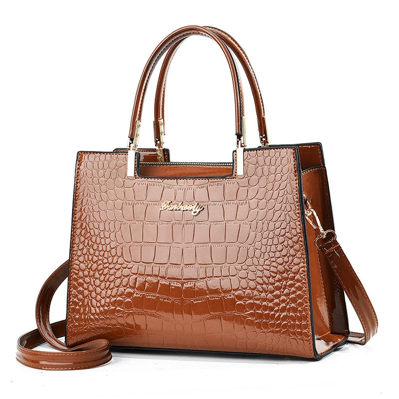 Brown croc-texture tote with top handles and shoulder strap, structured rectangular bag