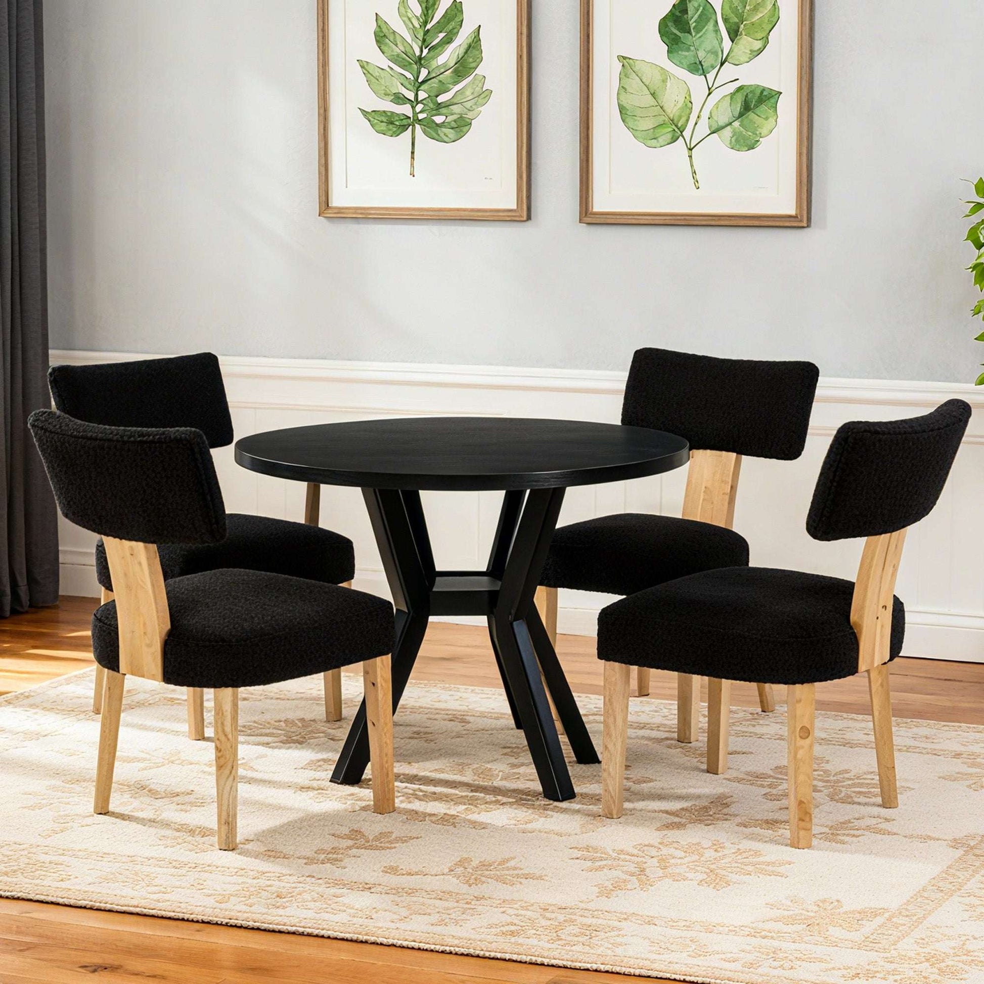 Set of 4 black upholstered dining chairs with light wood legs and curved seat backs