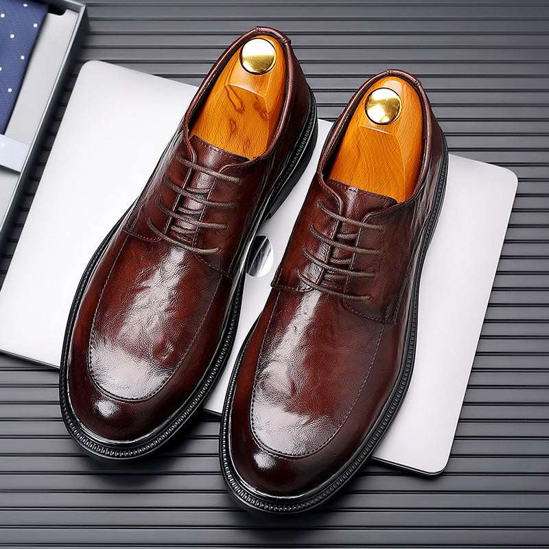 Brown leather lace-up dress shoes with polished toe caps, orange lining, and pair view