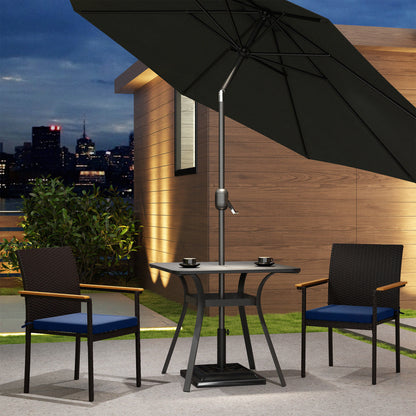 Wicker patio dining chair with dark frame, blue seat cushion, and wood armrest