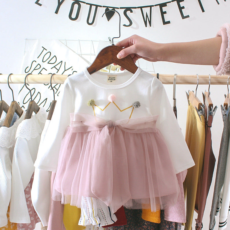 Baby girl dress with white top, pink tulle skirt, flower accents, and gathered bow waist
