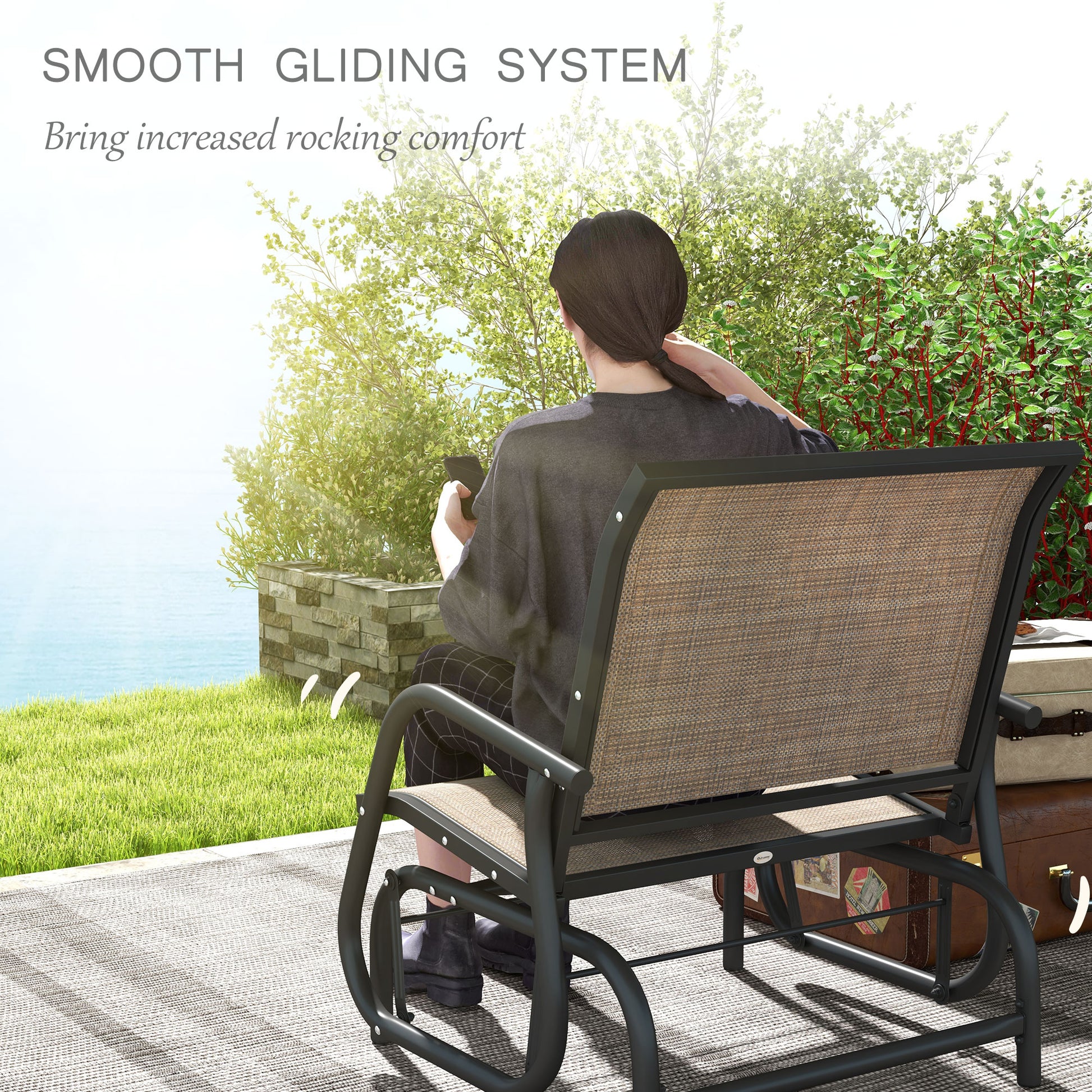 Outdoor steel glider chair with black frame and tan seat and backrest in motion