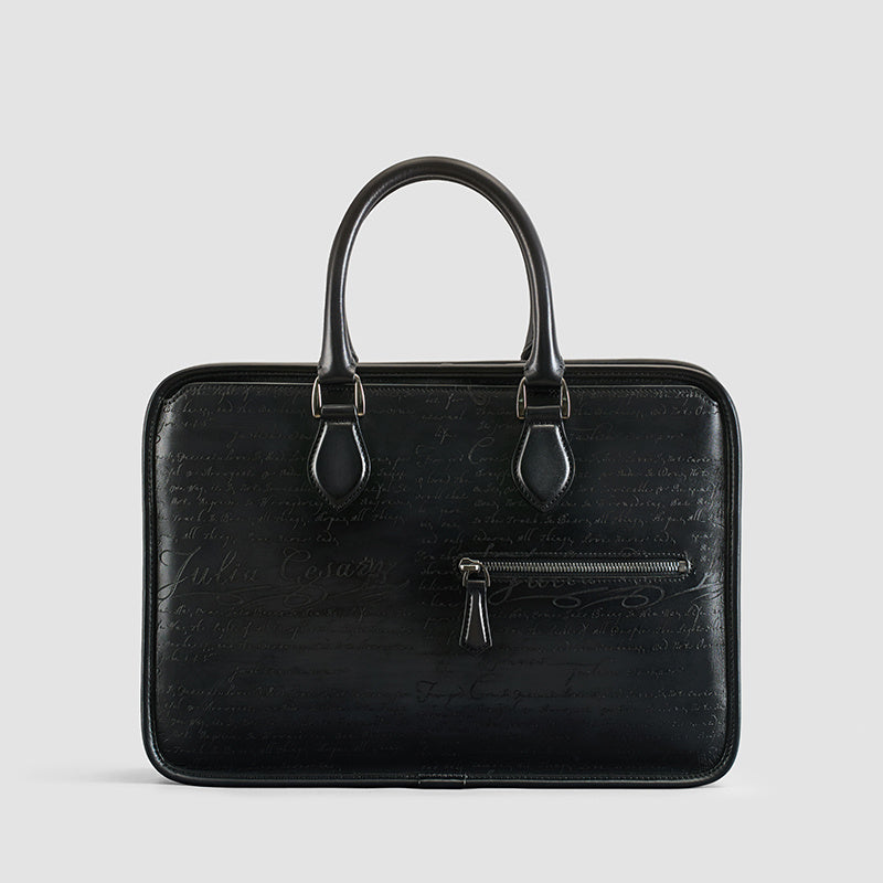 Men's vintage leather business bag in black with subtle script texture and front zip pocket