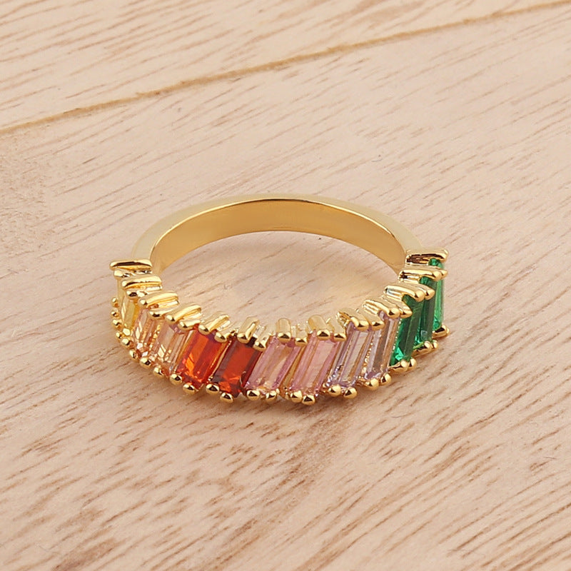 Gold-tone rainbow ring with baguette stones in green, red, pink, and purple