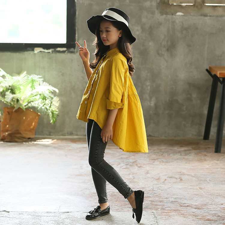Yellow girls' tunic shirt with button front, gathered yoke, and asymmetrical hem