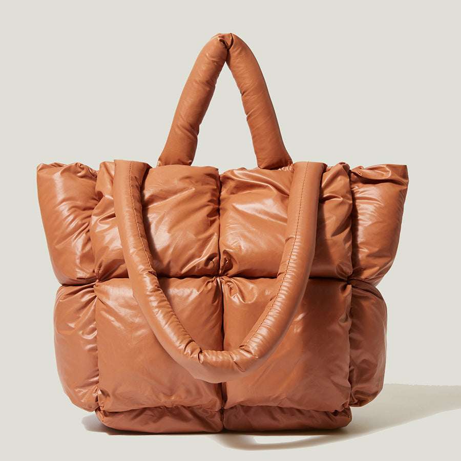 Orange puffer tote handbag with two top handles and quilted front sections