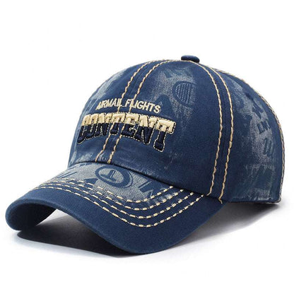 Washed blue baseball cap front-left view with embroidered logo patch and tan contrast seams