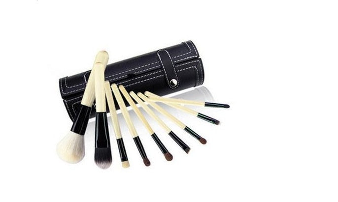 Makeup brush set with black pouch case and a fan of brushes with beige bristles