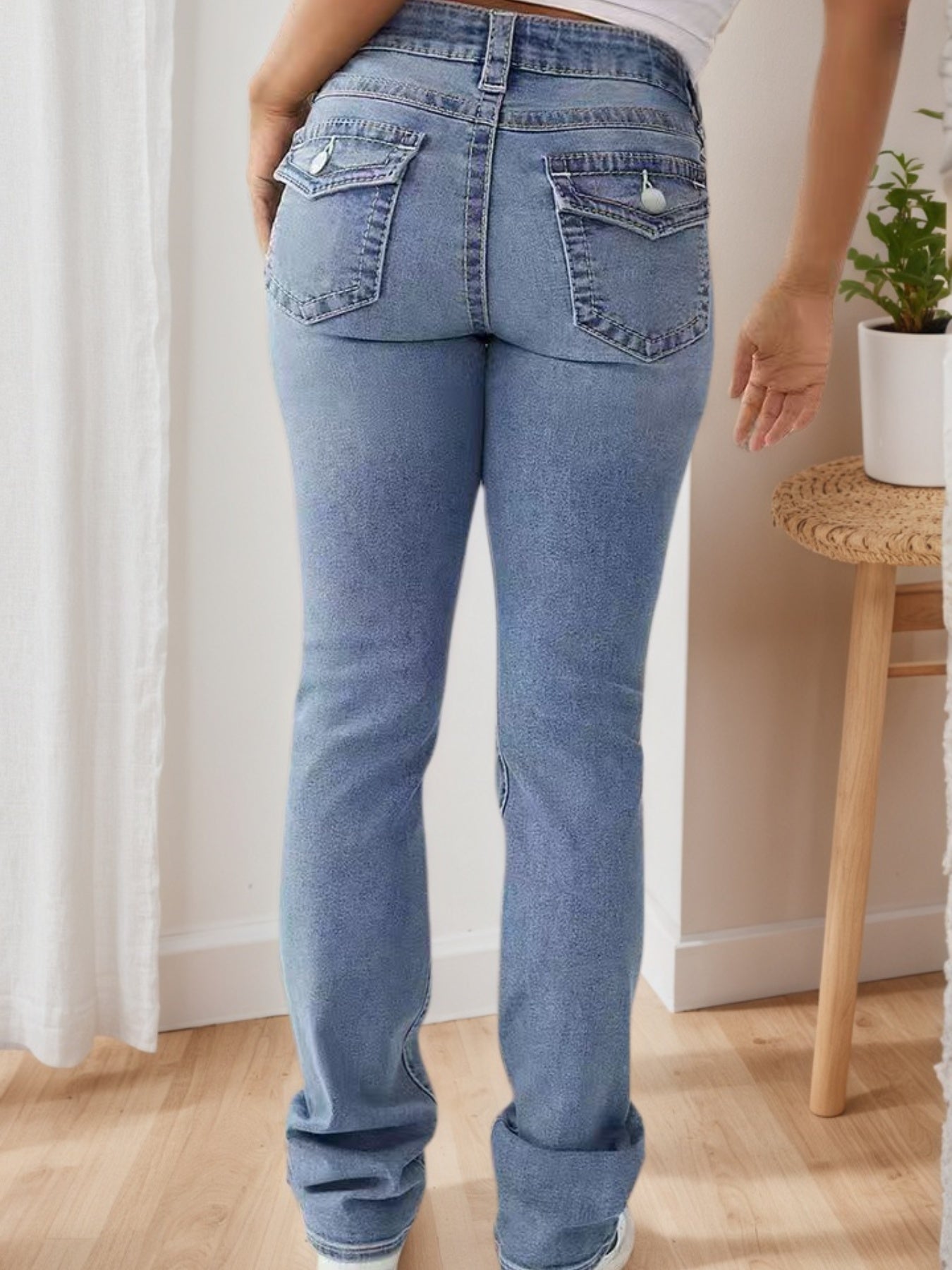 Light blue high-waisted wide-leg jeans, rear view with two back patch pockets