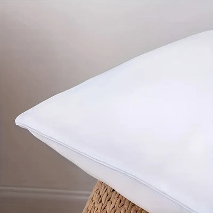White pillow corner with smooth fabric and neatly stitched edge