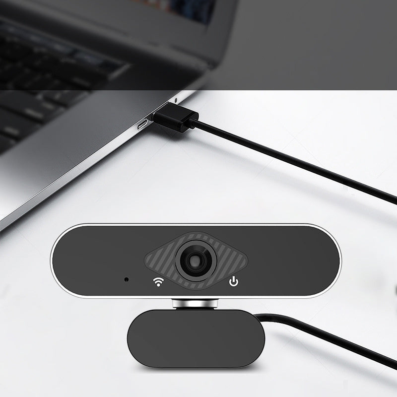 Webcam attached to a laptop on a white surface