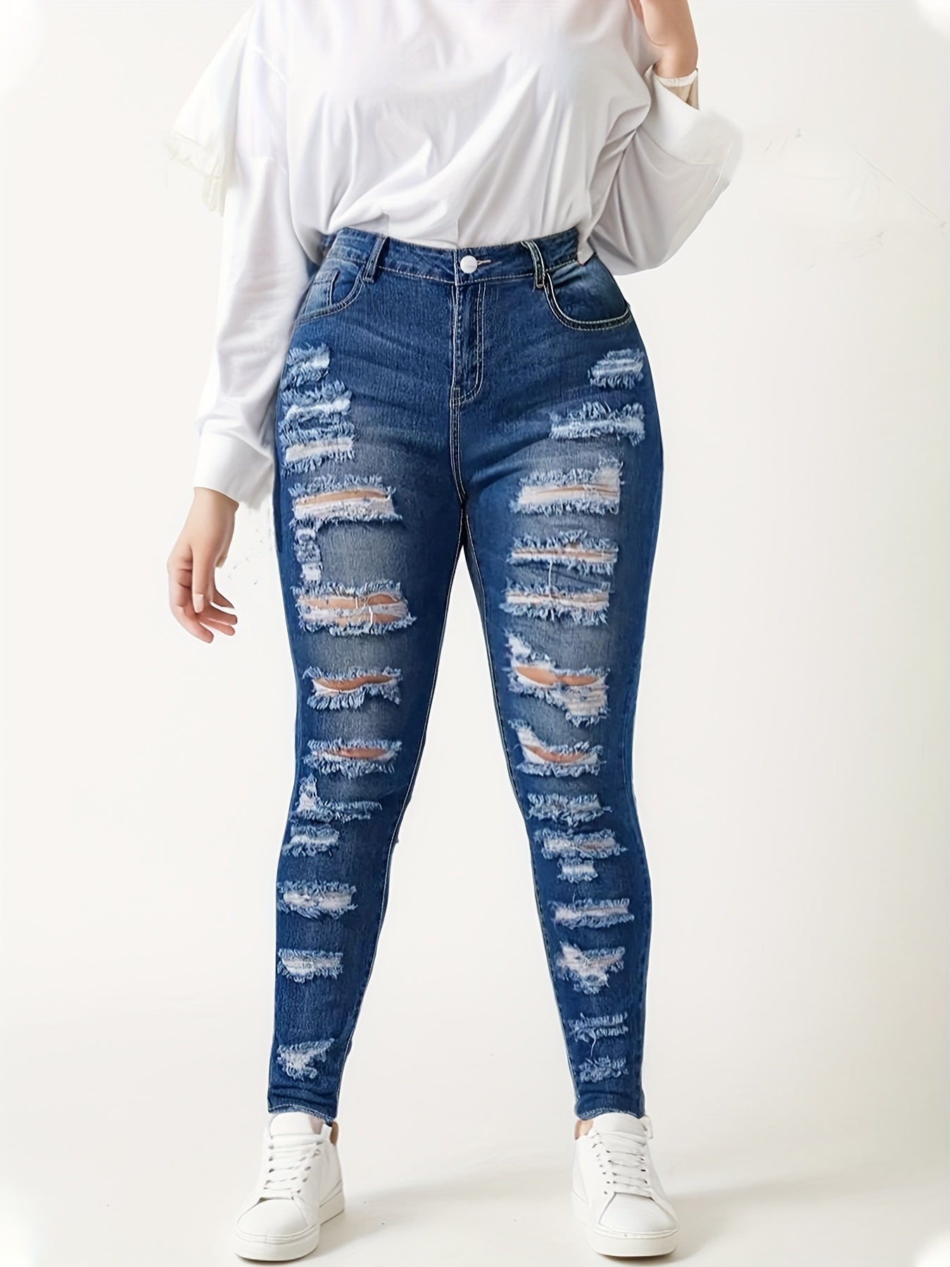 Women's blue ripped skinny jeans with stacked knee rips, high waist