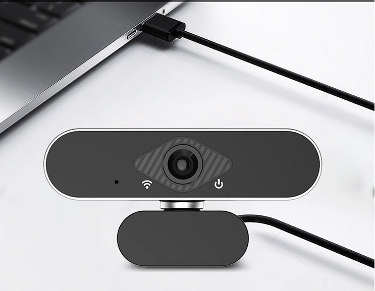 Webcam attached to a laptop on a white surface