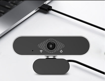 Webcam attached to a laptop on a white surface