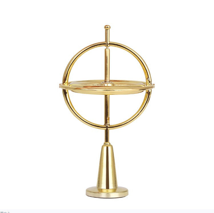 Gold self-balancing finger gyroscope with circular hoop and stand