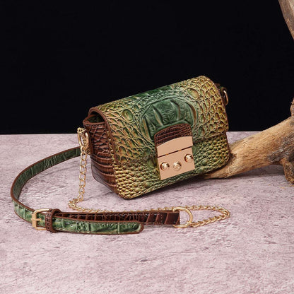 Green one-shoulder crossbody bag with crocodile texture and gold-tone clasp, chain strap.